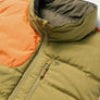 Up close image of an orange and tan puffer vest against a white background.