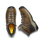 Pair of mid height shoes that are brown and black and one is laying on its side.
