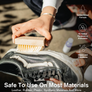 Someone cleaning a black shoe with a stiff bristled brush and Jason Markk shoe cleaner.