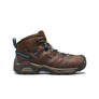 Brown and black shoe that has blue accents against a white background.