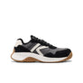 Black and white sneaker with brown sole on a white background