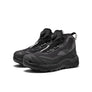 A pair of all black shoes that has Keen written on the side against a white background.