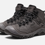 Pair of grey shoes with black accents and the Keen logo on the side and the tongue of the shoe against a white bqckground