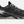 Side view of a black shoe with tan and white accents against a white background.
