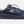 Side view of a dark blue and brown shoe with white accents that has a big white letter K on the side and the word 'aspire' on the back outside heel of the shoe.