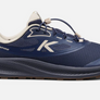 Side view of a dark blue and brown shoe with white accents that has a big white letter K on the side and the word 'aspire' on the back outside heel of the shoe.