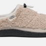 Side view of a Tan pair of fuzzy shoes that has a black rubber sole with a Keen logo on the side and a draw string on top against a white background.