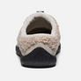 Back view of a Tan fuzzy slide on shoe with black rubber sole against a white background.