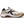 Side view of a white shoe with tan and black accents that has a large black K on the side of the shoe.