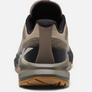 Back view of a light brown shoe with black and dark brown accents against a white background.