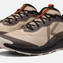 A Pair of tan shoes with varying shades of brown and orange accents that has a large light brown K on the side of the shoe.