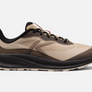 Side view of a tan shoe that has dark brown and burnt orange accents and a let letter K in a light brown color on the side of the shoe.