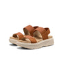 Pair of brown sandals with beige platforms on a white background