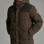 Close up image of a person wearing a dark brown jacket with their hands in the pockets against a medium grey background.