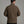 Back view of a person wearing a dark brownish green jacket.