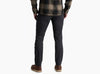 Person wearing dark grey pants with a flannel against a white background.