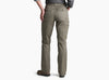 Back view of a person wearing pale dark green pants with a grey shirt against a white background.