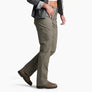 Person wearing pale dark green pants with a grey shirt and brown shoes against a white background.