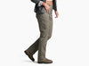 Person wearing pale dark green pants with a grey shirt and brown shoes against a white background.