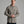 Person wearing a tan colored button up long sleeve shirt.