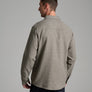 Back view of a person wearing a long sleeve tan shirt with a collar.