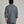 Back view of a person wearing a long sleeve shirt that is dark blue and has a collar.
