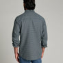 Back view of a person wearing a long sleeve shirt that is dark blue and has a collar.