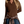 Person wearing a brown sweater with buttons that come 1/4 of the way down and has a brown and tan flannel tied around waste against a white background.