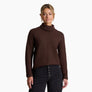 Person wearing a dark brown sweater against a white background.