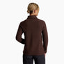 Person wearing a dark brown sweater against a white background.
