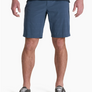 Person wearing blue shorts with a darker blue shirt and brown shoes against a white background.