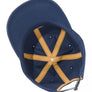 Navy blue cap with a yellow 'X' design on a white background