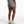 Person wearing gray shorts on a white background