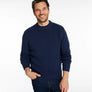 Person wearing a navy blue sweater against a white background.