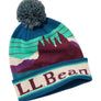 Tan hat with a multi color pattern of a mountain and a pom on top of the hat against a white background.