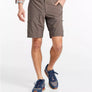 Person wearing brown cargo shorts on a white background