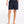 Person wearing black
shorts on a white background