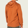 Back view of a person wearing burnt orange hoodie against a white backgroud.