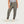 Person wearing olive green jogger pants on a white background