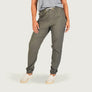 Person wearing olive green jogger pants on a white background
