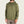 Person wearing a green 1/4 zip pullover with a brand logo on a beige background