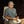 Person sitting in a lawn chair wearing a grey short sleeve button up shirt eating BBQ food at night