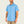 Man wearing a light blue button-up shirt with a logo on a plain background