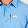 Close-up of a blue shirt with a Marsh logo on a light background