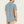Person wearing a grey short sleeve shirt with tan pants on a blank background