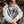 Person wearing a light blue 1/4 zip pull over sitting in nature