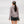 Person wearing grey shorts with a fishing pole against a white background