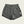 Gray shorts with a brand label on a beige background