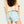 Back view of person wearing frosty green shorts on a plain background
