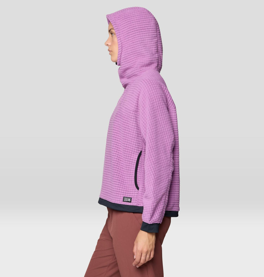 Person wearing a purple textured hoodie on a light gray background